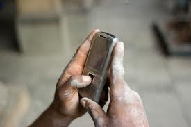 Cell Phone in Contruction Worker's Hands